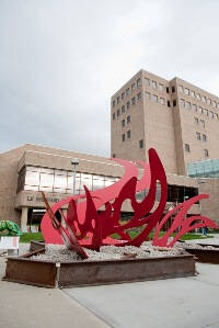 Red abstract wave-like sculpture.